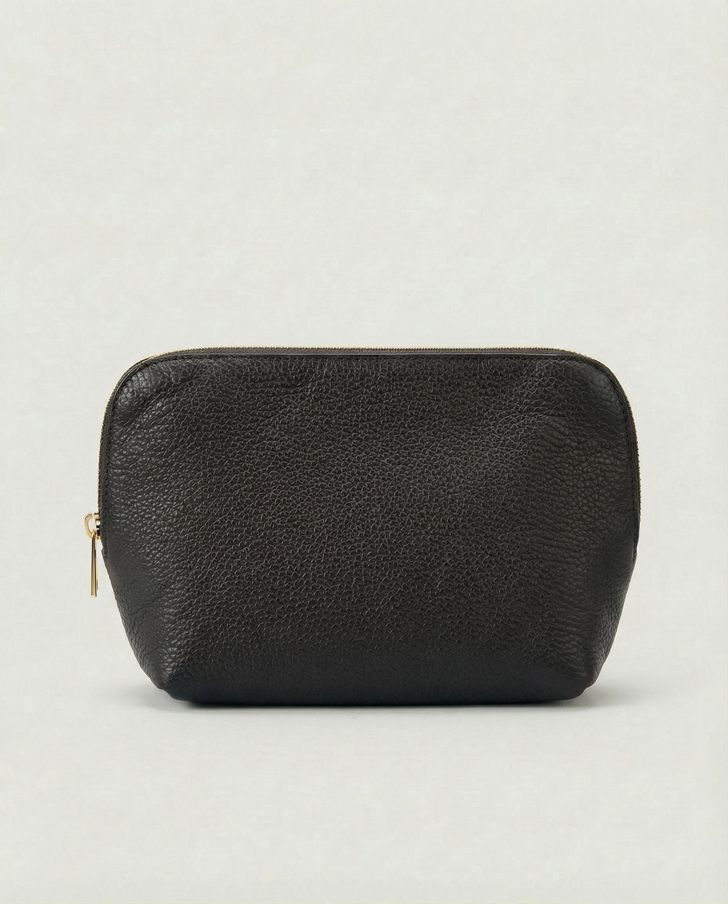 Pebble leather cosmetic bag with zip closure, available in black, structured silhouette for everyday essentials.