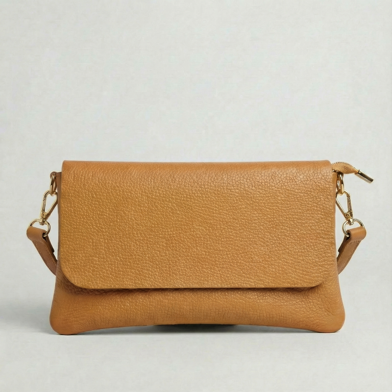 Camel pebble leather crossbody bag with a matching color adjustable strap, displayed on a light gray background.