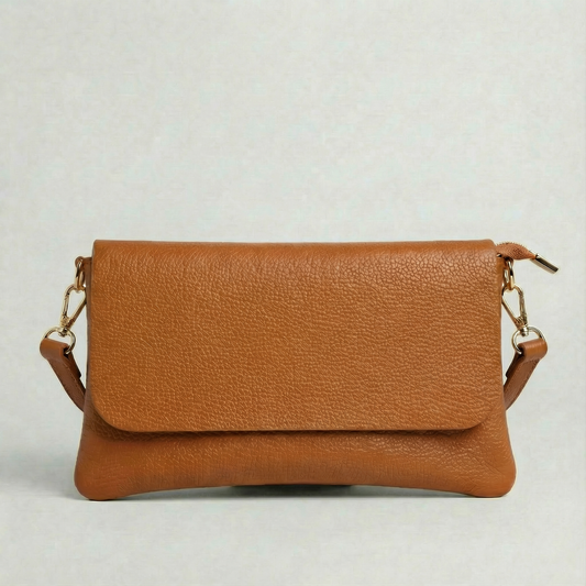 Caramel leather cellphone wallet  with leather strap in same color on a light gray background