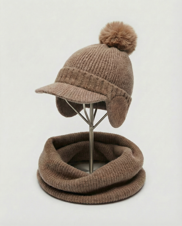 Brown knit hat with pom-pom and matching neckwarmer on a mannequin stand against a white background