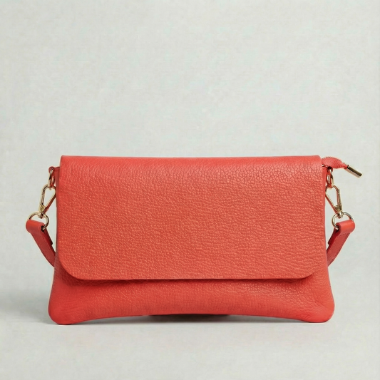 Coral pebble leather crossbody bag with a matching color adjustable strap, displayed on a light gray background.