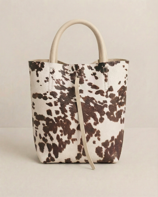 Mini tote in pebble leather cow with structured silhouette and top handles, compact and bold design.
