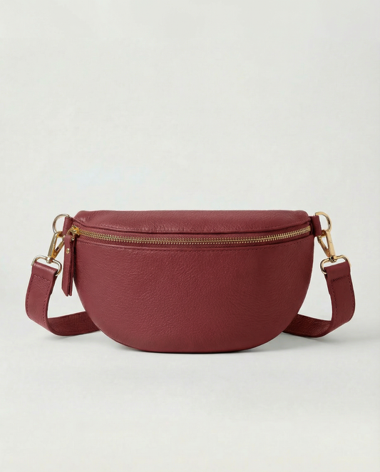 Cranberry pebble leather fanny bag with adjustable strap and compact, hands‑free design.