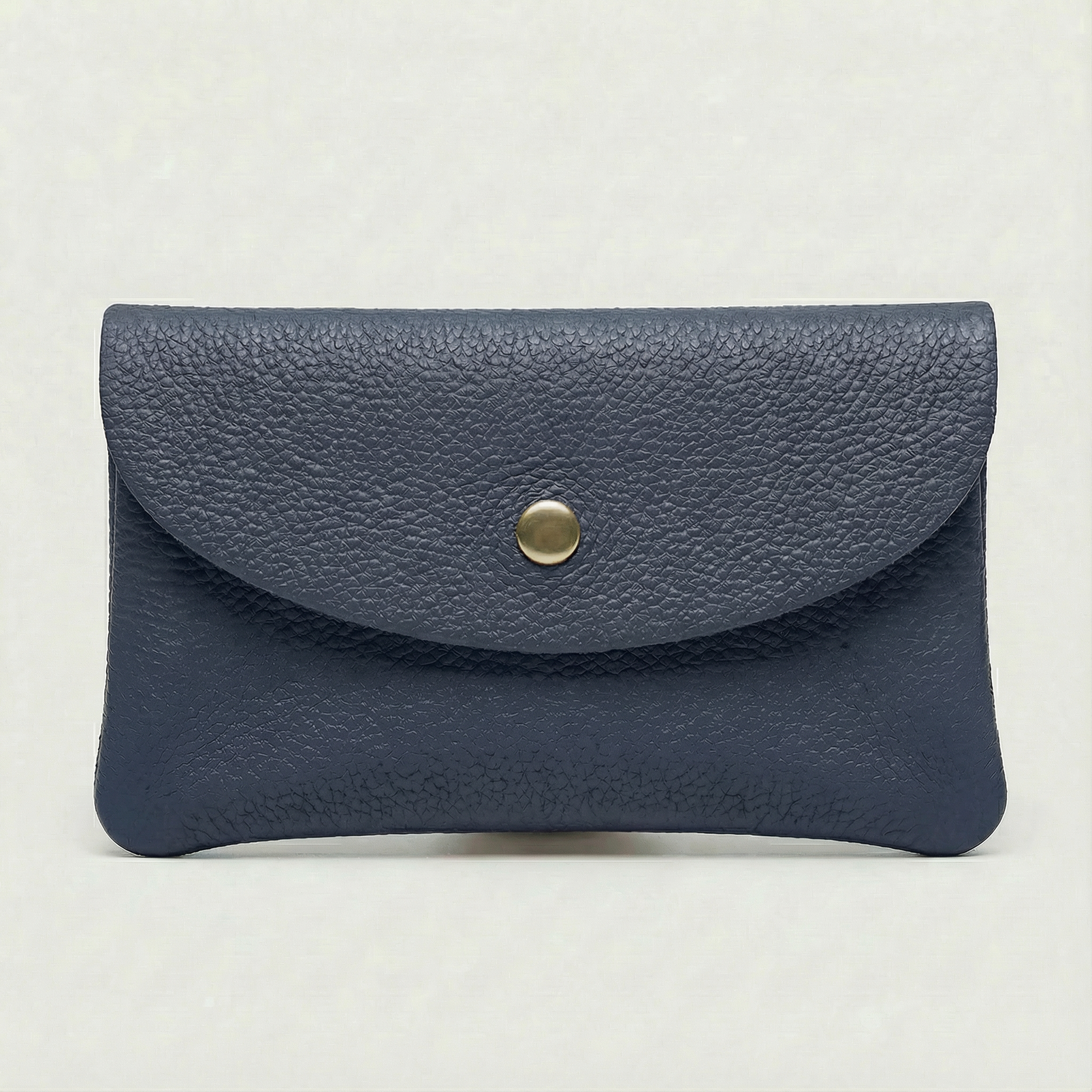 Navy blue leather wallet with a gold button on a light gray background