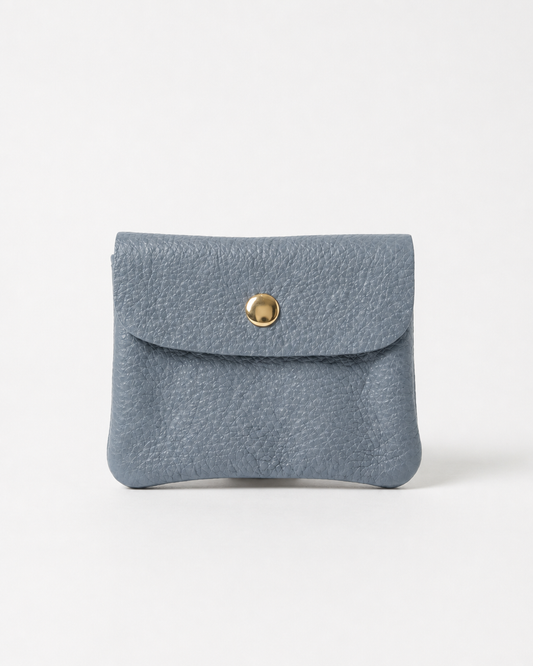 Denim pebble leather mini coin wallet with snap closure, compact Italian‑made design for coins and small essentials
