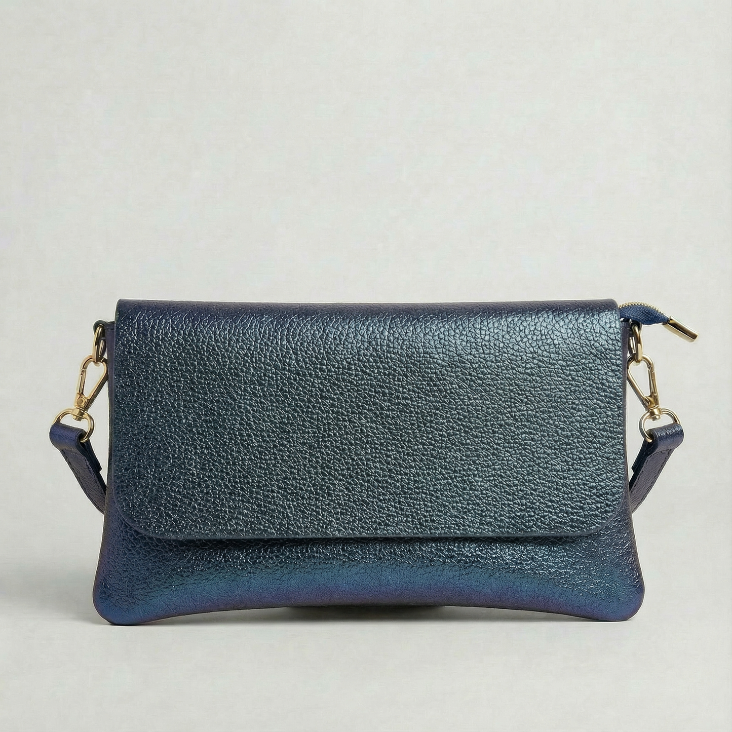 Denim metallic leather crossbody bag with a matching color leather strap, displayed on a light gray background.