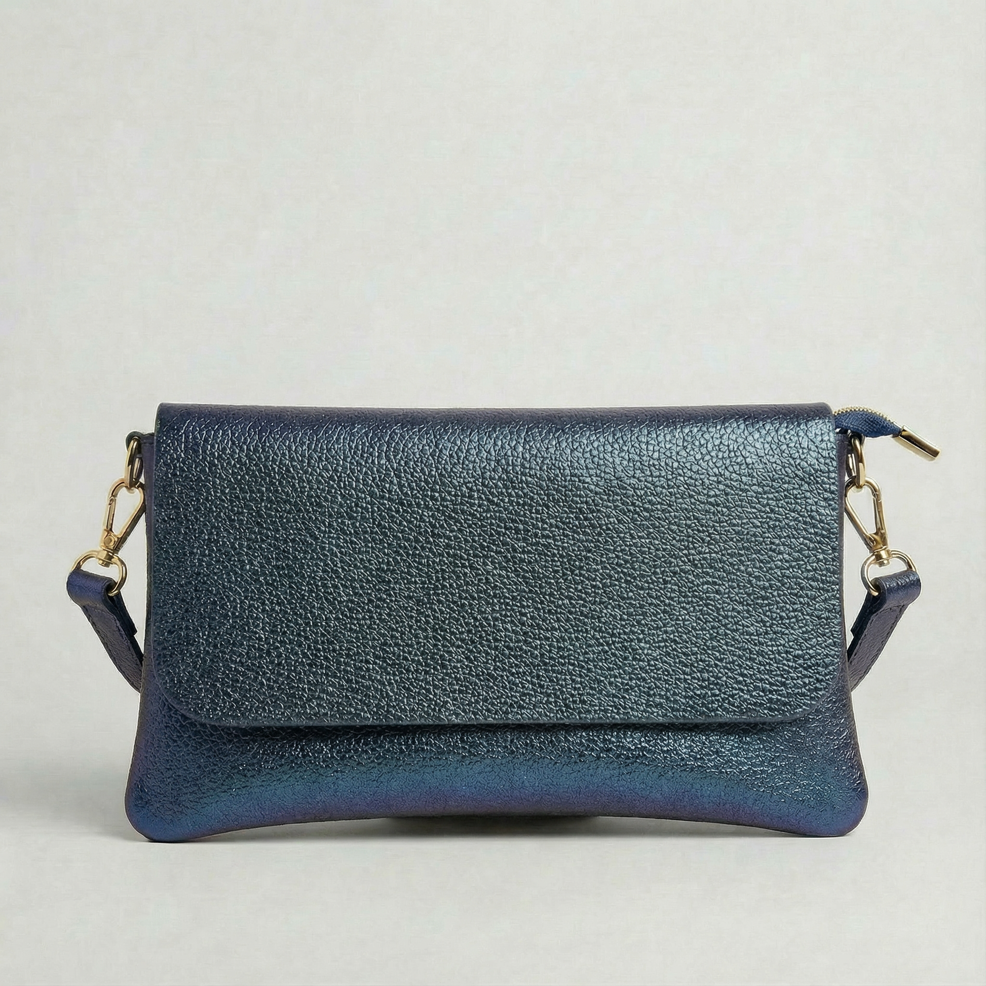 Denim metallic leather crossbody bag with a matching color leather strap, displayed on a light gray background.
