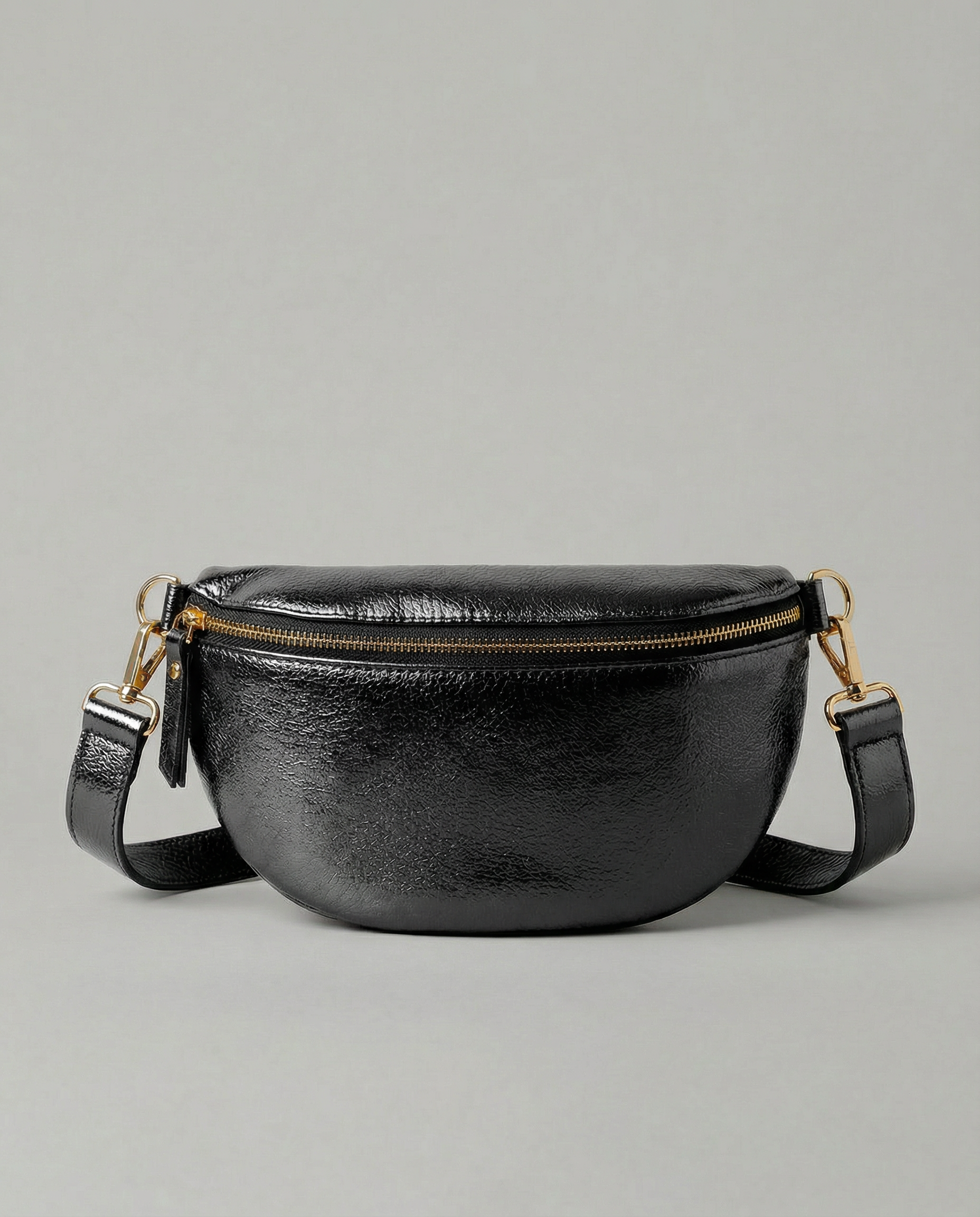 Metallic leather fanny bag in black with adjustable strap and sleek, compact silhouette designed for hands‑free everyday wear.
