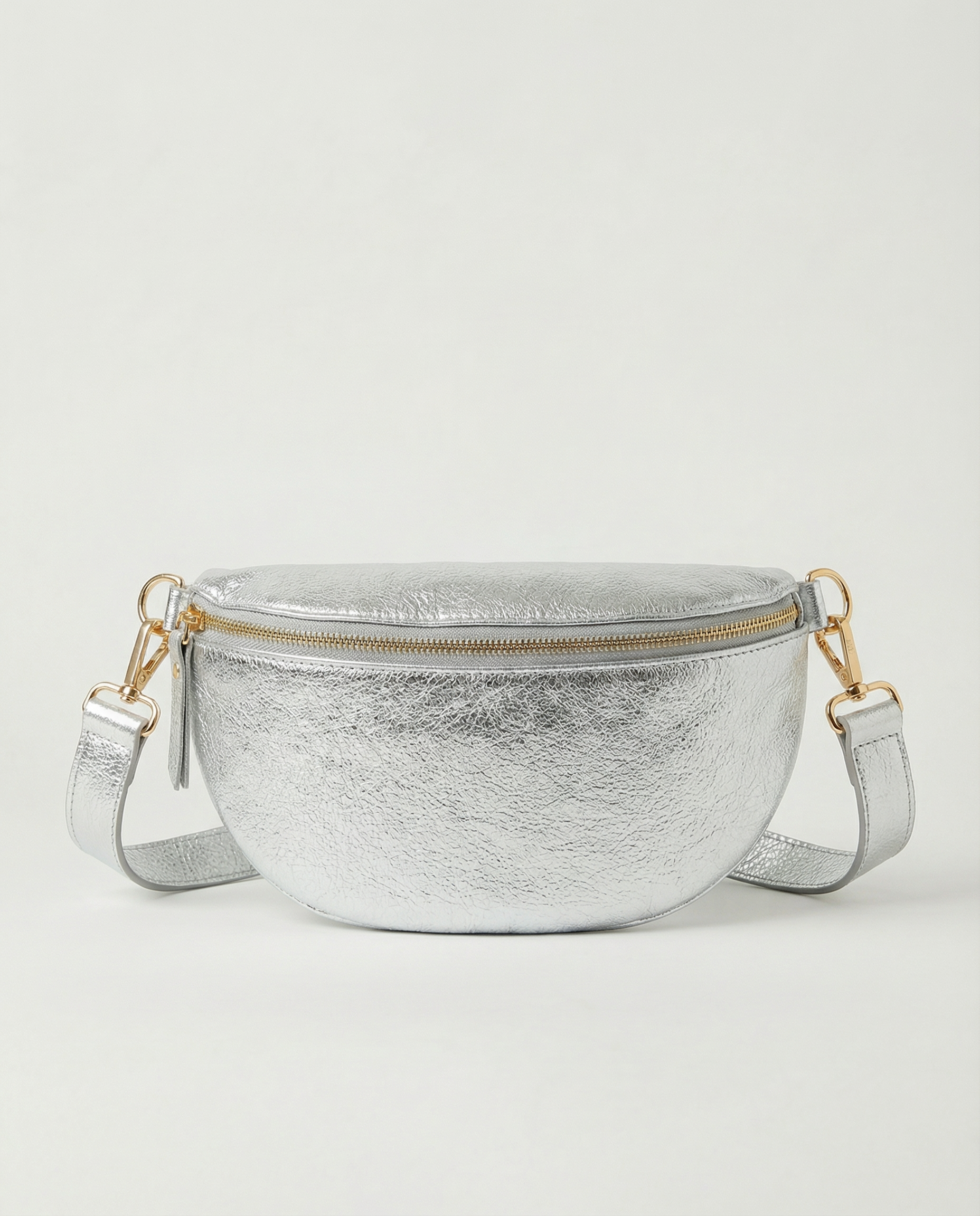Metallic leather fanny bag in silver with adjustable strap and sleek, compact silhouette designed for hands‑free everyday wear.