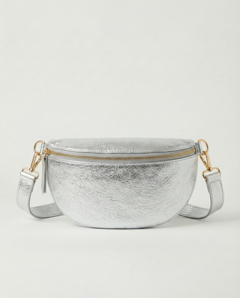 Metallic leather fanny bag in silver with adjustable strap and sleek, compact silhouette designed for hands‑free everyday wear.