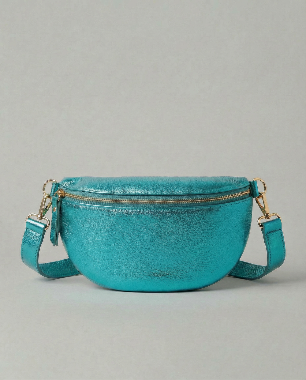 Metallic leather fanny bag in turquoise with adjustable strap and sleek, compact silhouette designed for hands‑free everyday wear.