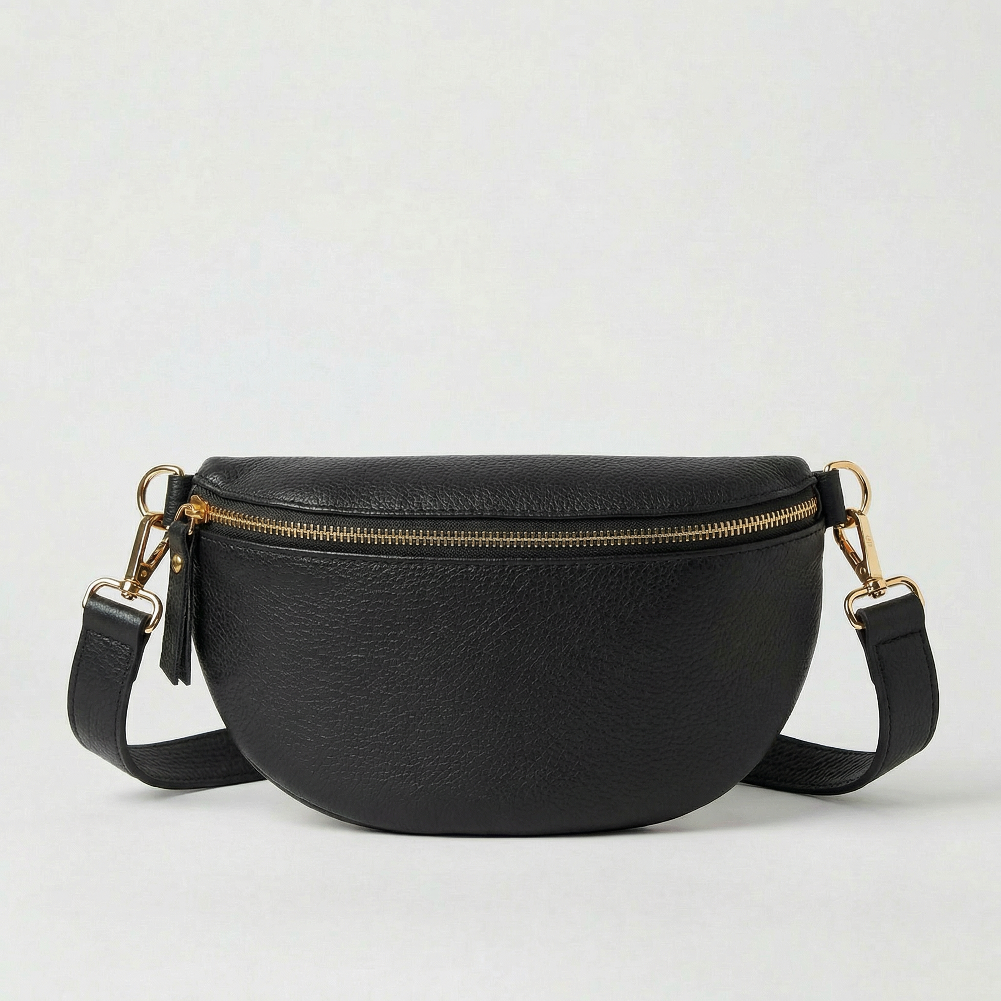 Black pebble leather fanny bag with adjustable strap and compact, hands‑free design.