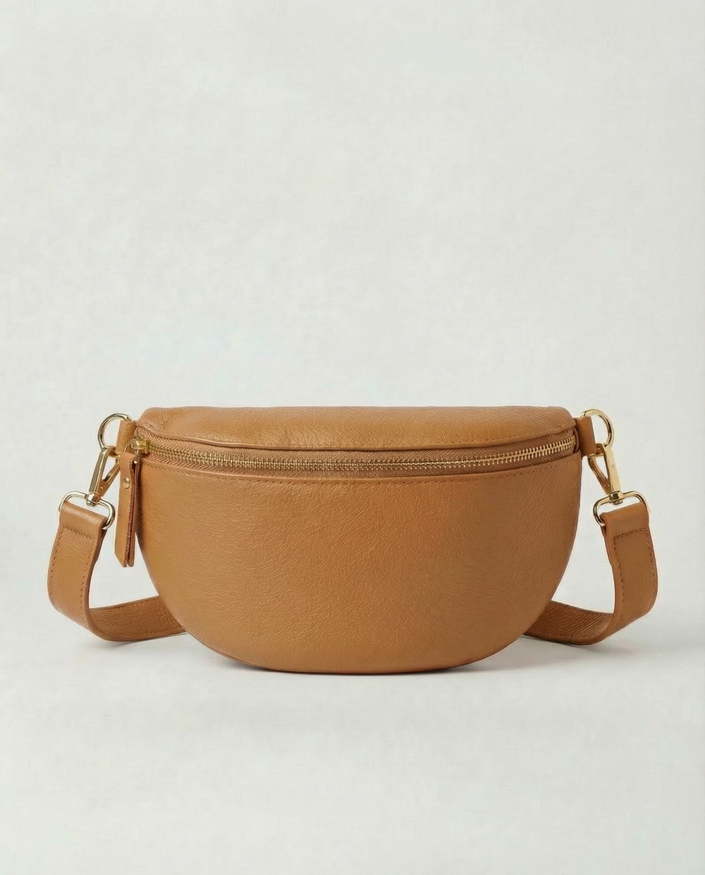 Camel pebble leather fanny bag with adjustable strap and compact, hands‑free design.
