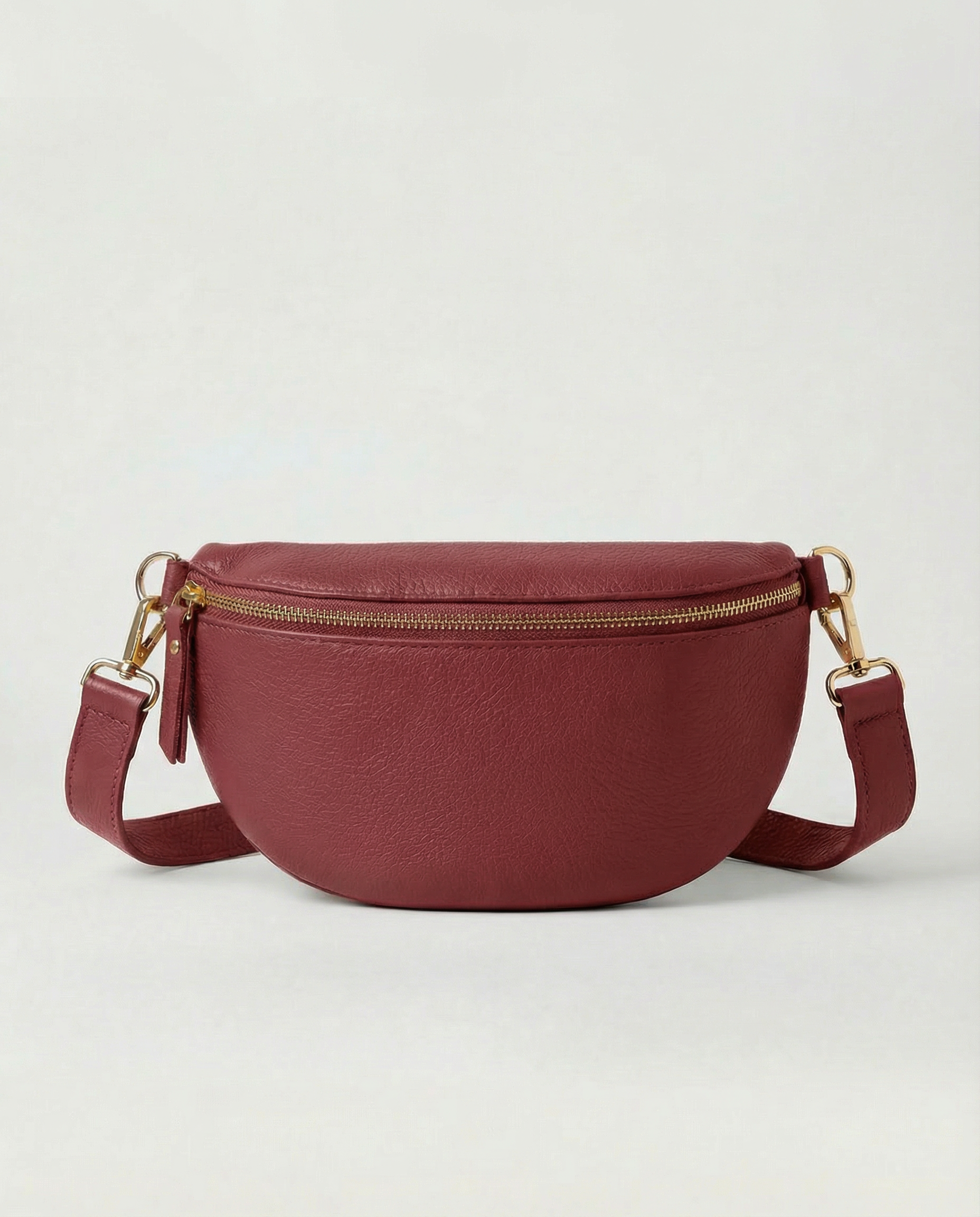 Cranberry pebble leather fanny bag with adjustable strap and compact, hands‑free design.