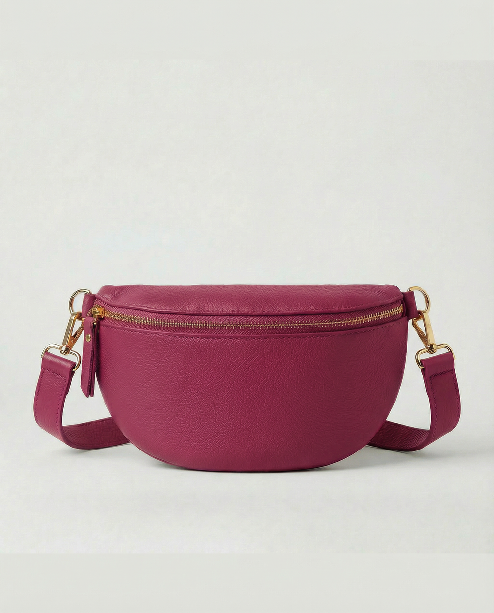 Magenta pebble leather fanny bag with adjustable strap and compact, hands‑free design.