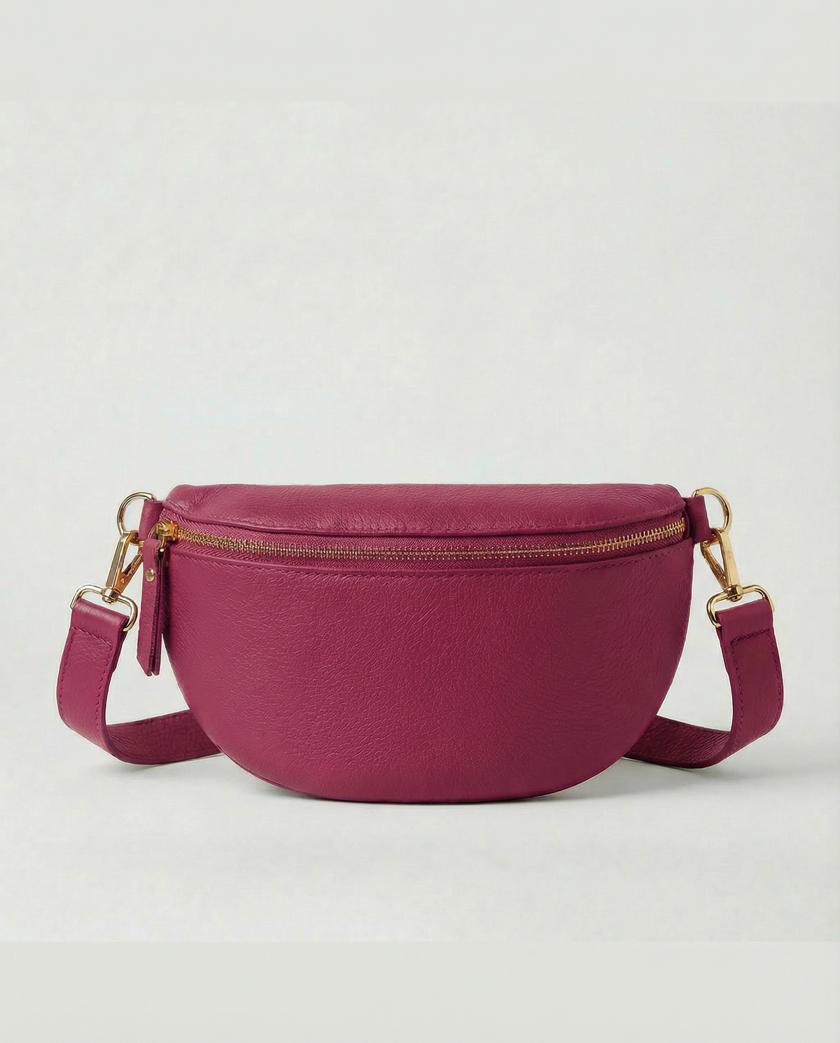 Magenta pebble leather fanny bag with adjustable strap and compact, hands‑free design.