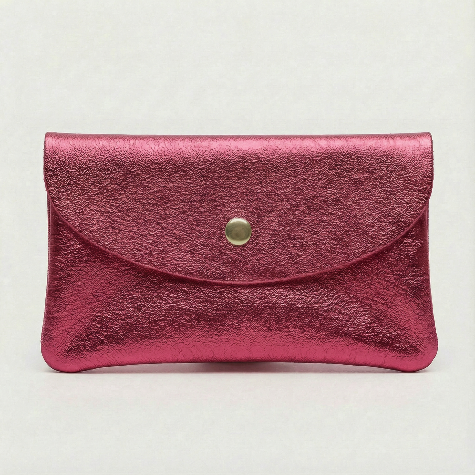 Flamingo metallic leather cellphone wallet with a gold button on a light gray background