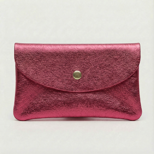 Flamingo metallic leather cellphone wallet with a gold button on a light gray background