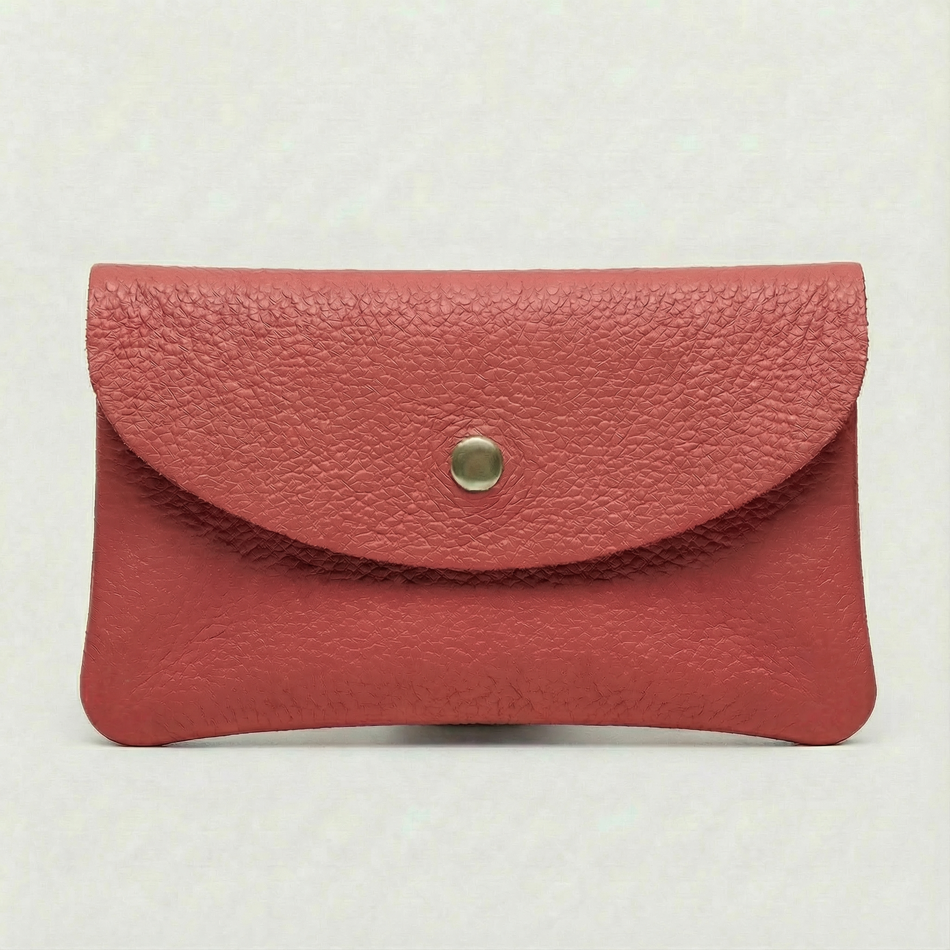Flamingo color leather cellphone wallet with a gold button on a white background.