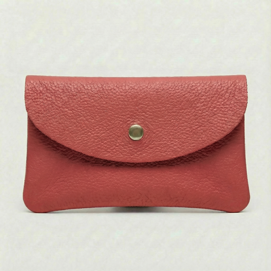 Flamingo color leather cellphone wallet with a gold button on a white background.