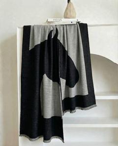 Gray and black blanket with horse design draped over a white surface, view 2