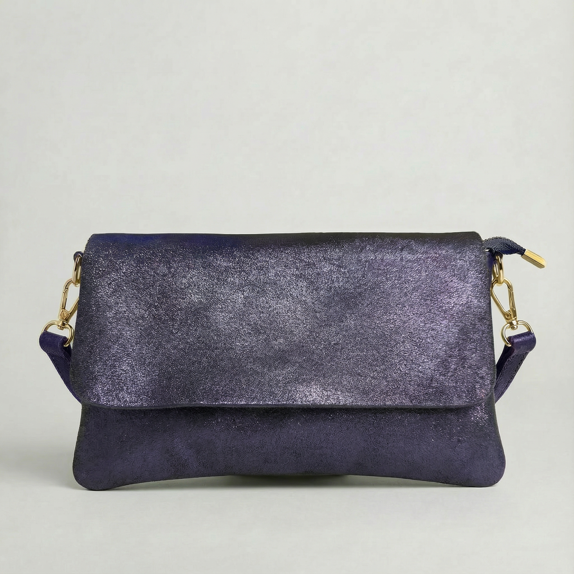 Indigo metallic leather crossbody bag with a matching color leather strap, displayed on a light gray background.