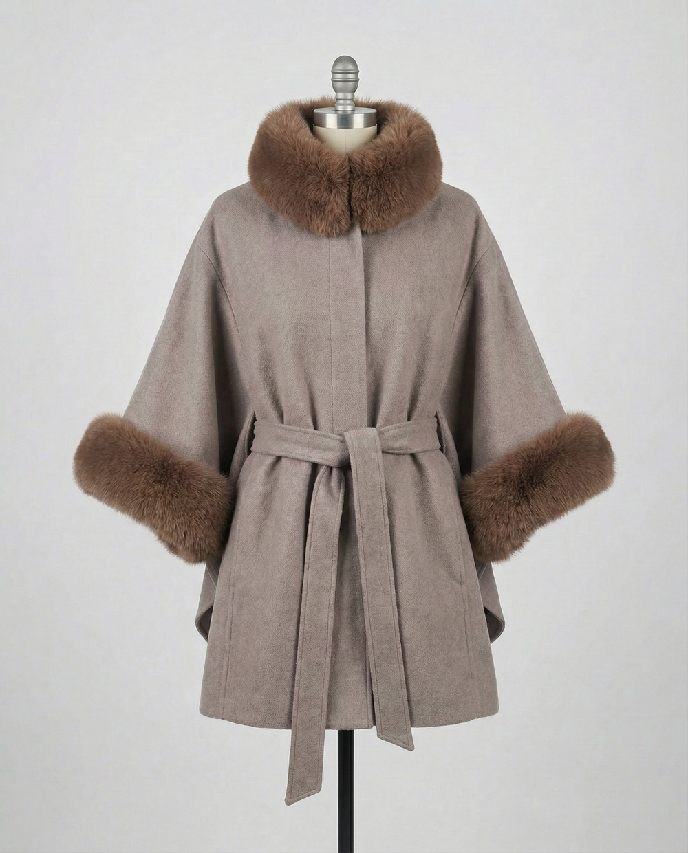 Mocha Janelle coat with brown fur trim on a mannequin against a gray background.