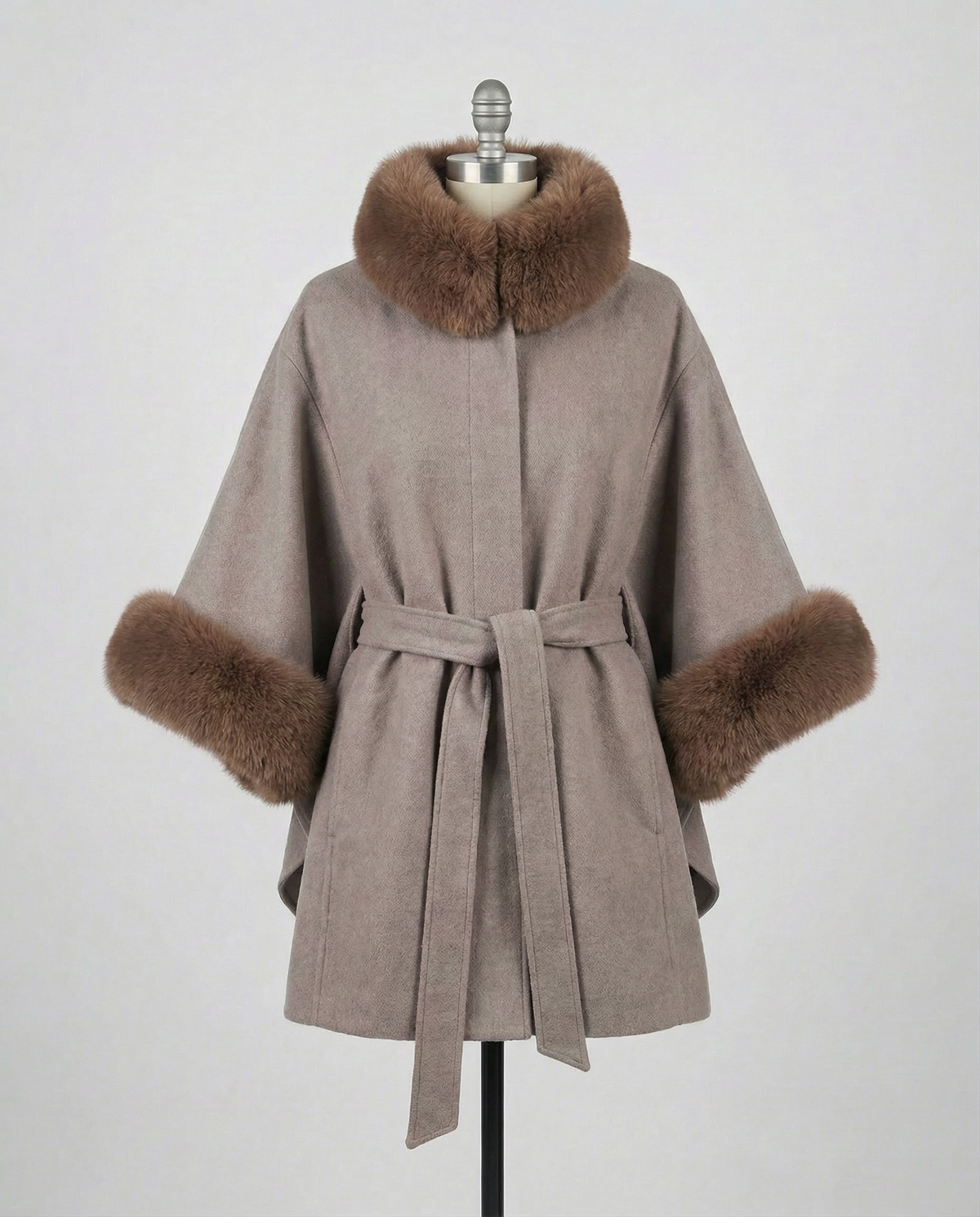 Mocha Janelle coat with brown fur trim on a mannequin against a gray background.