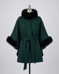 Green coat with black fur trim on a mannequin against a gray background, view 1