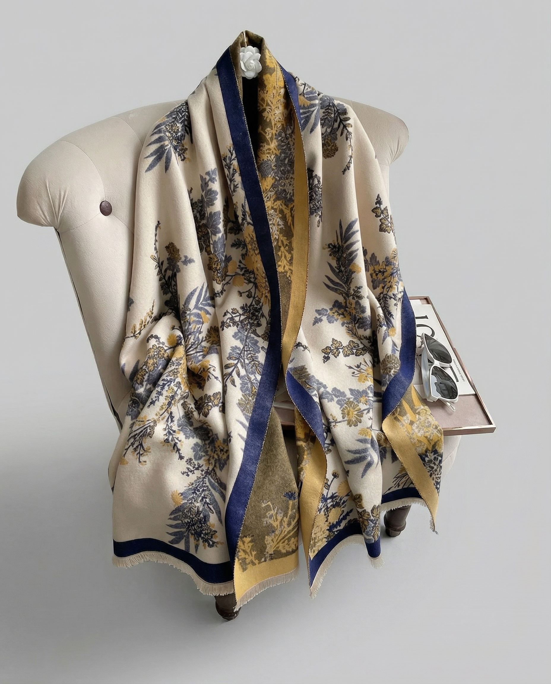 Floral patterned scarf draped over a mannequin on a gray background