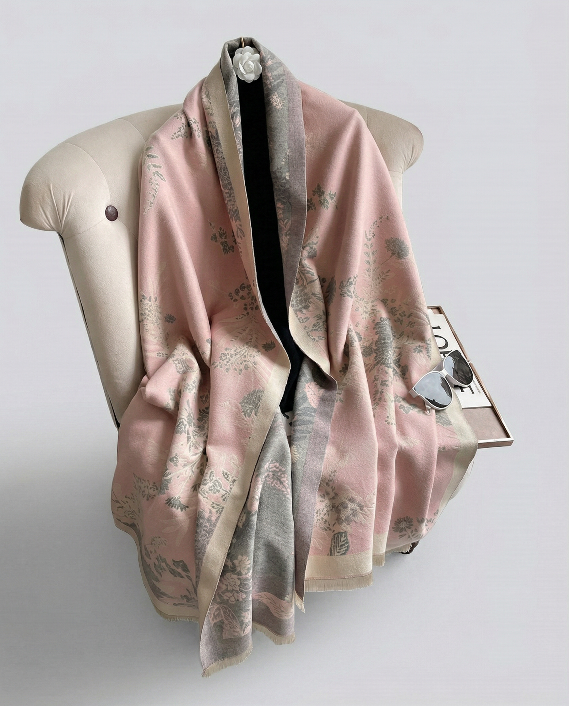 Pink floral scarf draped over a mannequin on a light gray background