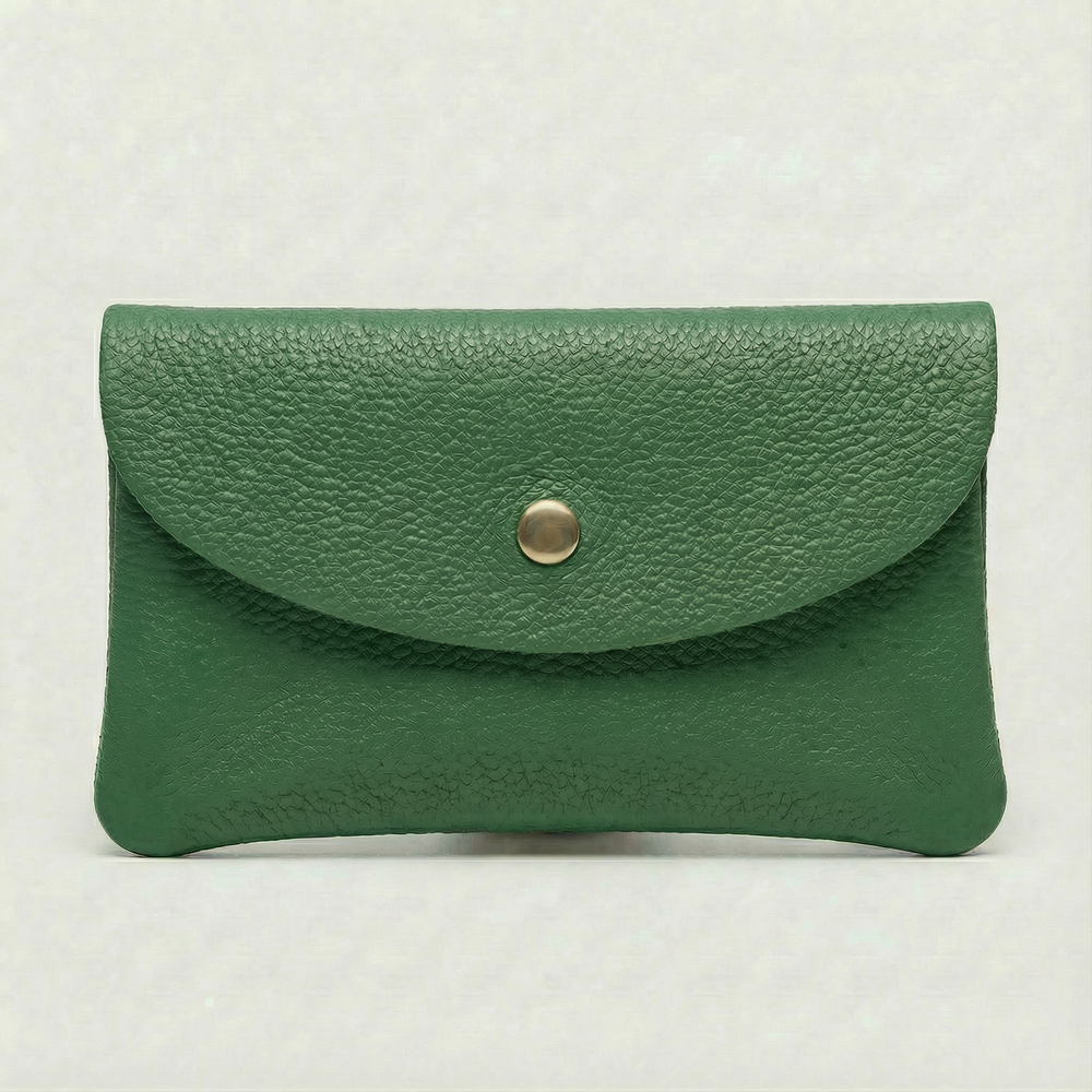 Kelly green leather wallet with a gold button on a light gray background
