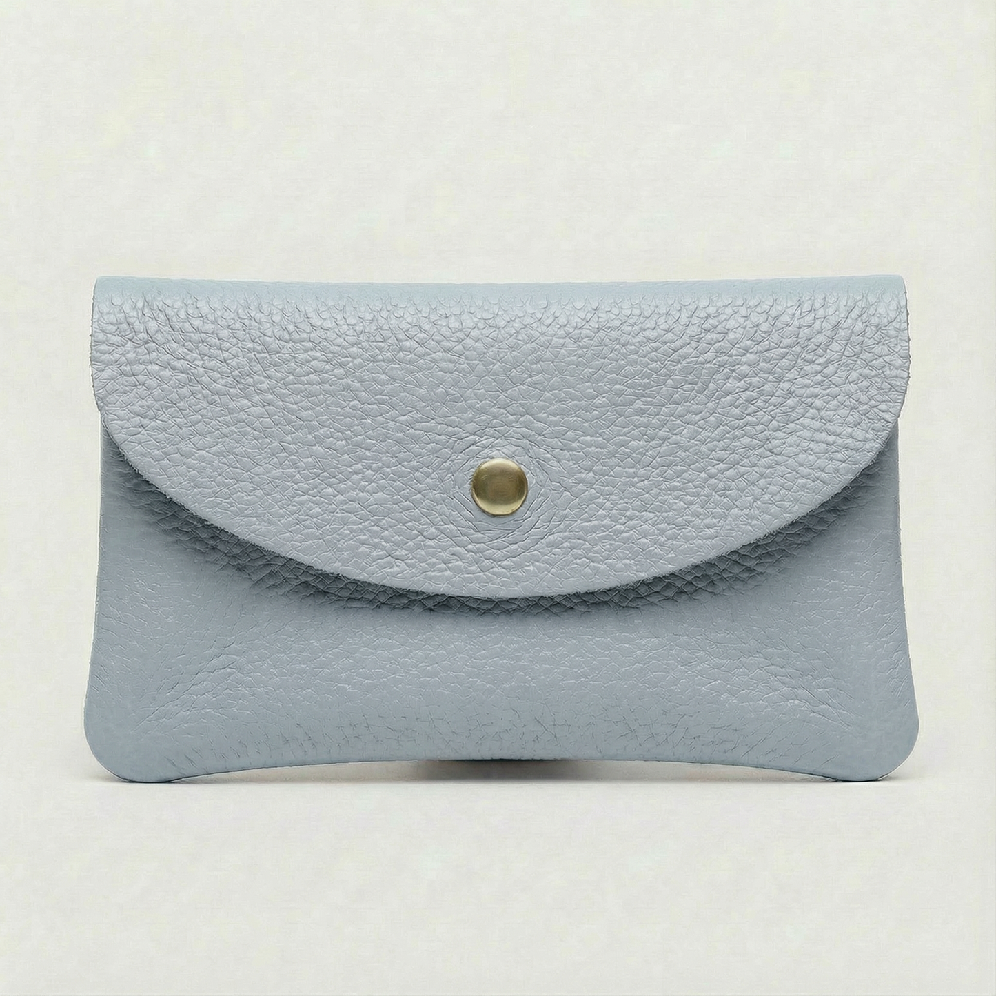 Light Blue pebble leather coin wallet with snap closure, minimalist Italian design, compact and elegant everyday accessory.