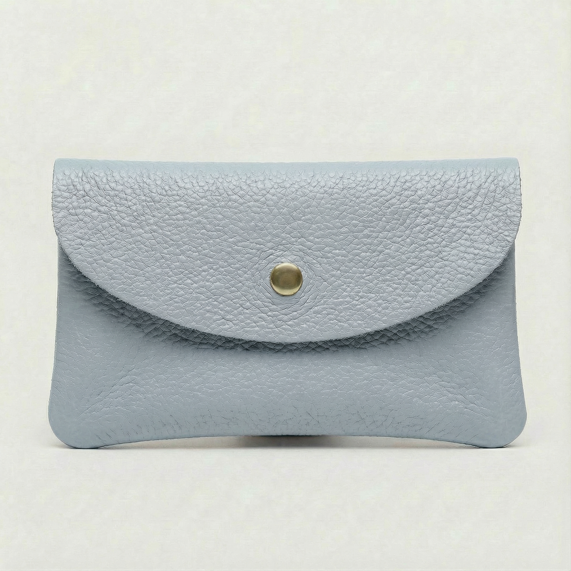 Light Blue pebble leather coin wallet with snap closure, minimalist Italian design, compact and elegant everyday accessory.