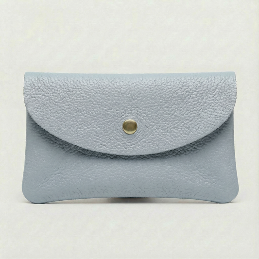 Light Blue pebble leather coin wallet with snap closure, minimalist Italian design, compact and elegant everyday accessory.