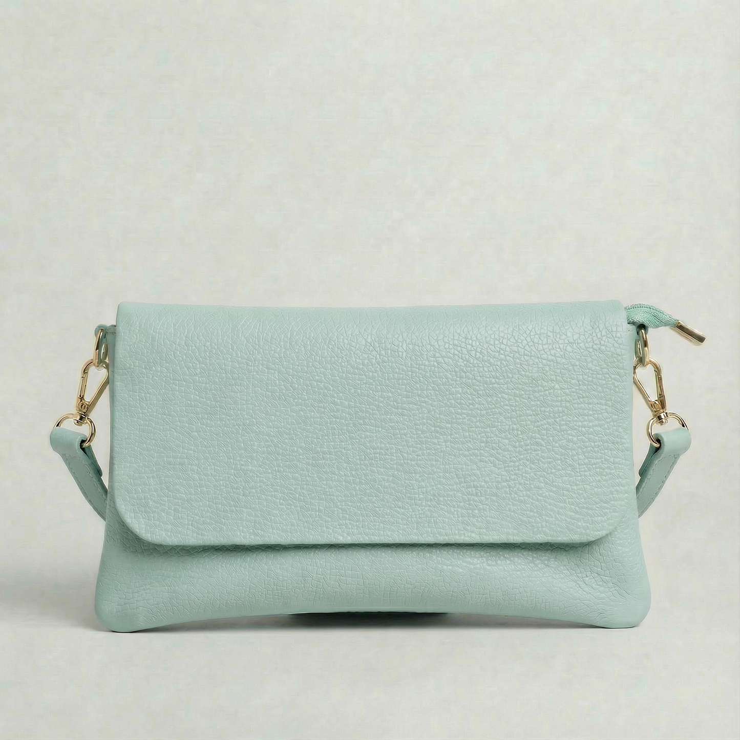 Light Blue pebble leather crossbody bag with a matching color adjustable strap, displayed on a light gray background.