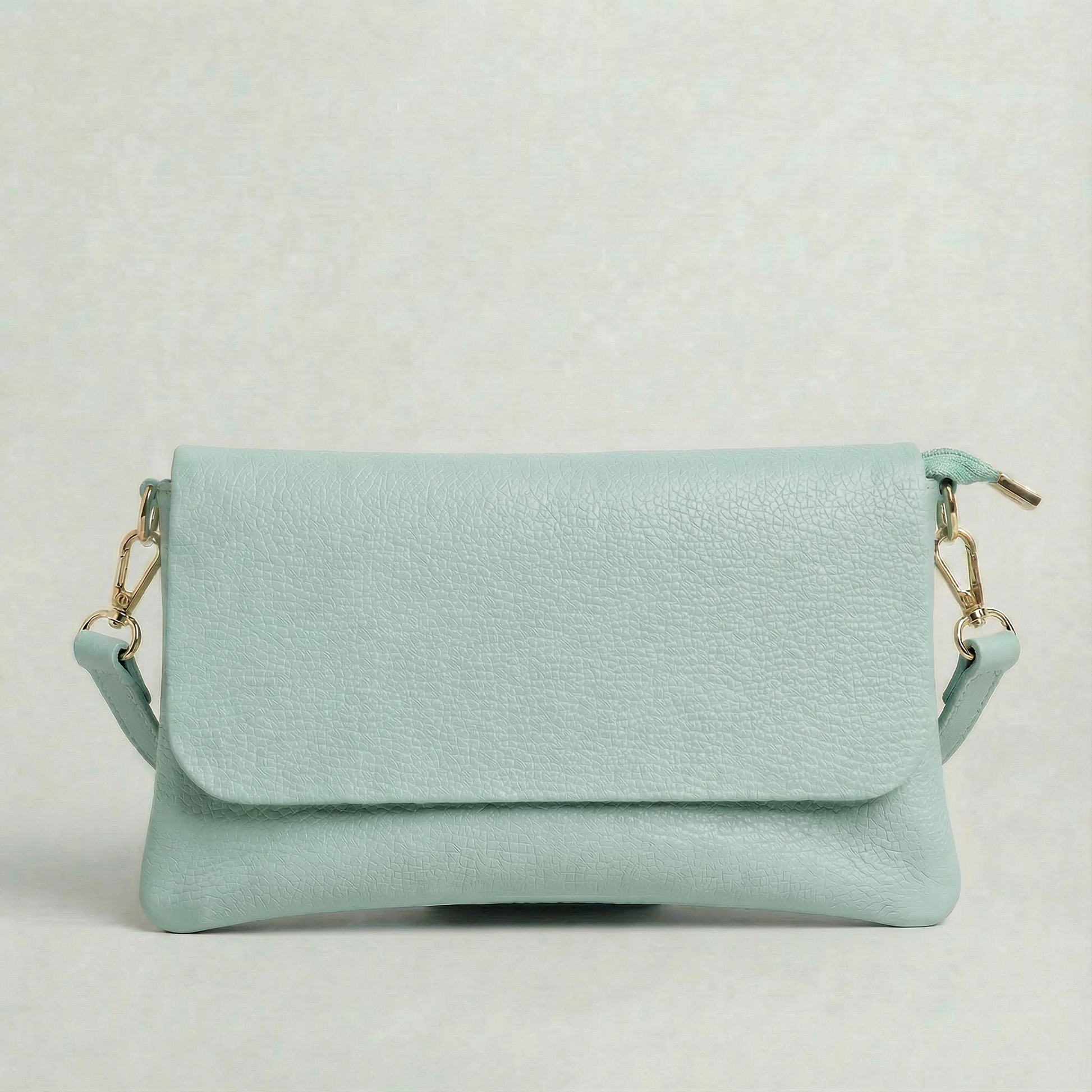 Light Blue pebble leather crossbody bag with a matching color adjustable strap, displayed on a light gray background.