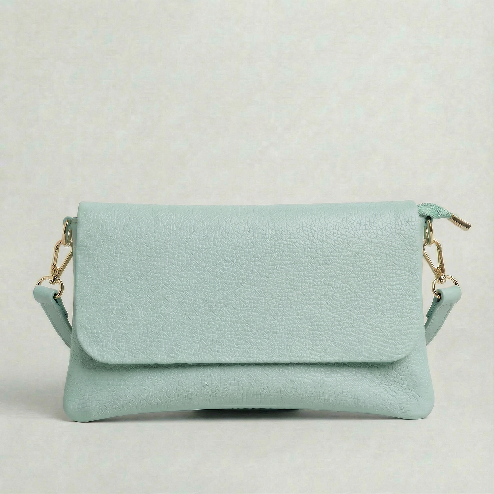 Light Blue pebble leather crossbody bag with a matching color adjustable strap, displayed on a light gray background.
