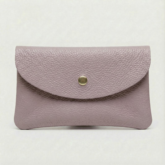Lilac pebble leather coin wallet with snap closure, minimalist Italian design, compact and elegant everyday accessory.