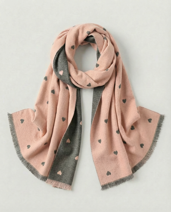 Two-toned pink and gray scarf with heart patterns on a light gray background
