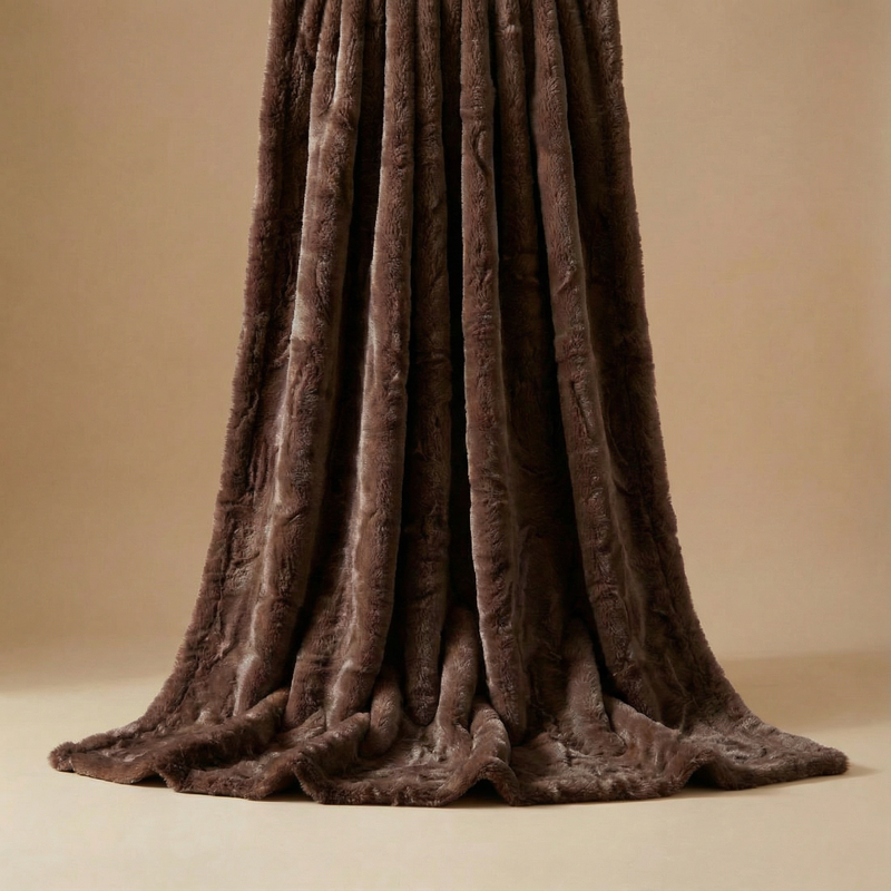 Chocolate-brown faux rabbit throw blanket vertically draped, highlighting its ultra-soft texture and rich, elegant folds against a warm neutral background.