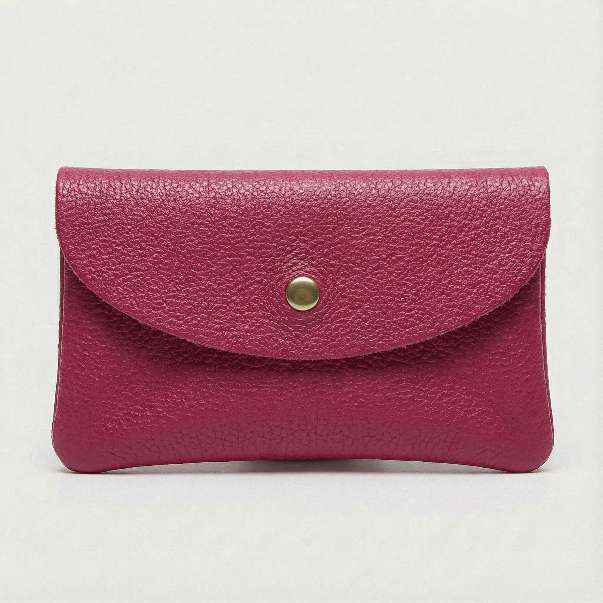 Magenta leather cellphone wallet with a gold button on a light gray background