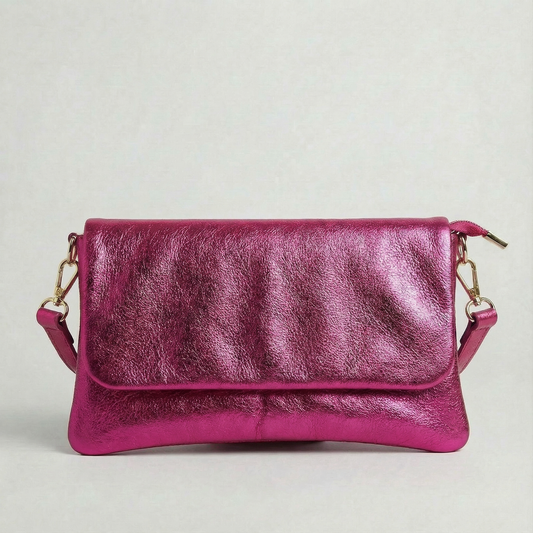 Magenta metallic leather crossbody bag with a matching color leather strap, displayed on a light gray background.
