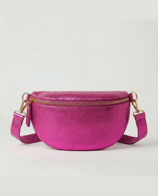 Metallic leather fanny bag in magenta with adjustable strap and sleek, compact silhouette designed for hands‑free everyday wear.