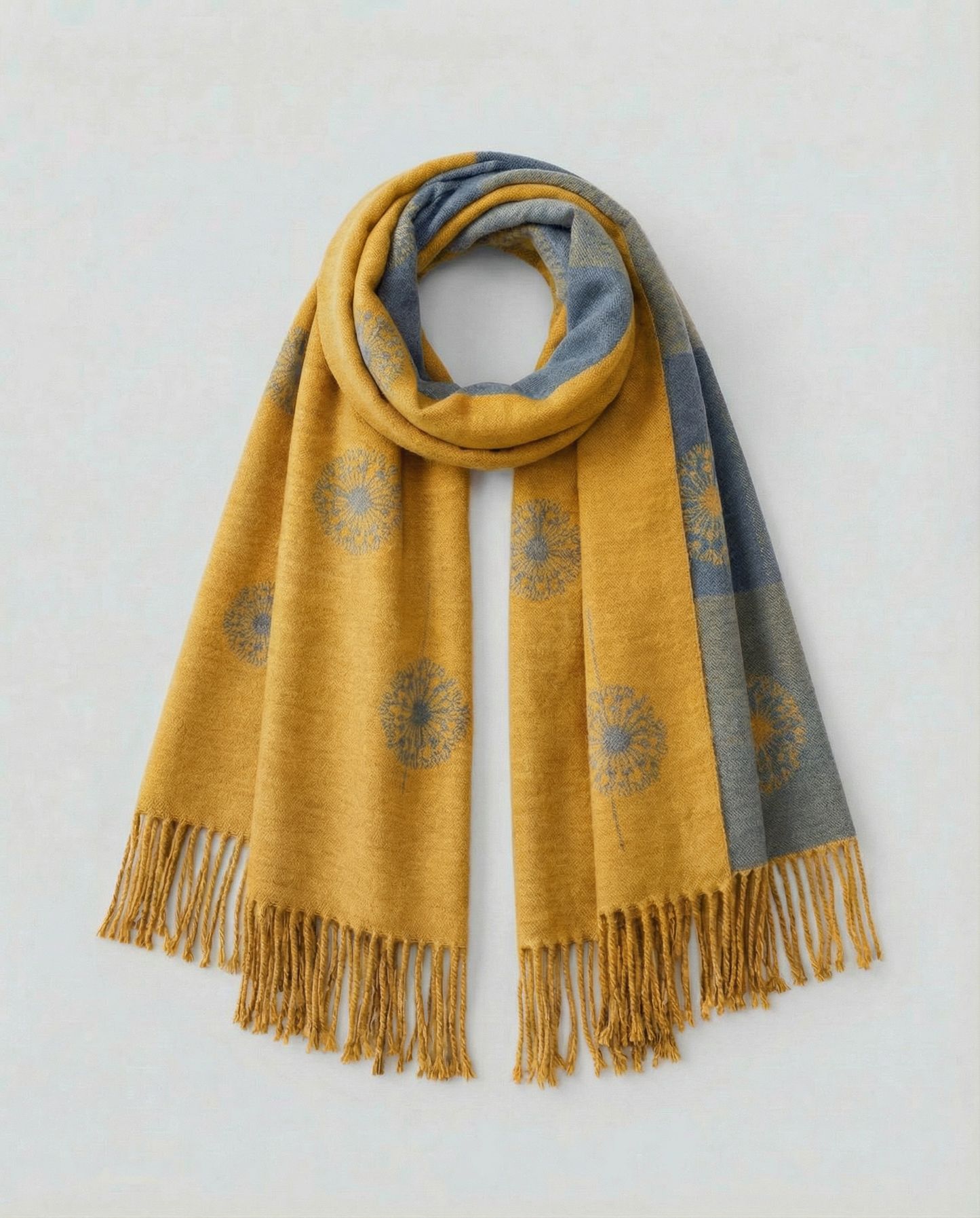 Yellow and gray patterned wrap with fringes on a light background