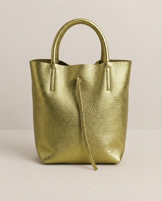 Mini tote in metallic pistachio leather with structured silhouette and top handles, sleek and compact design.