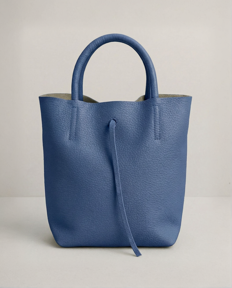Mini tote in pebble leather Royal blue with structured silhouette and top handles, compact and bold design. 