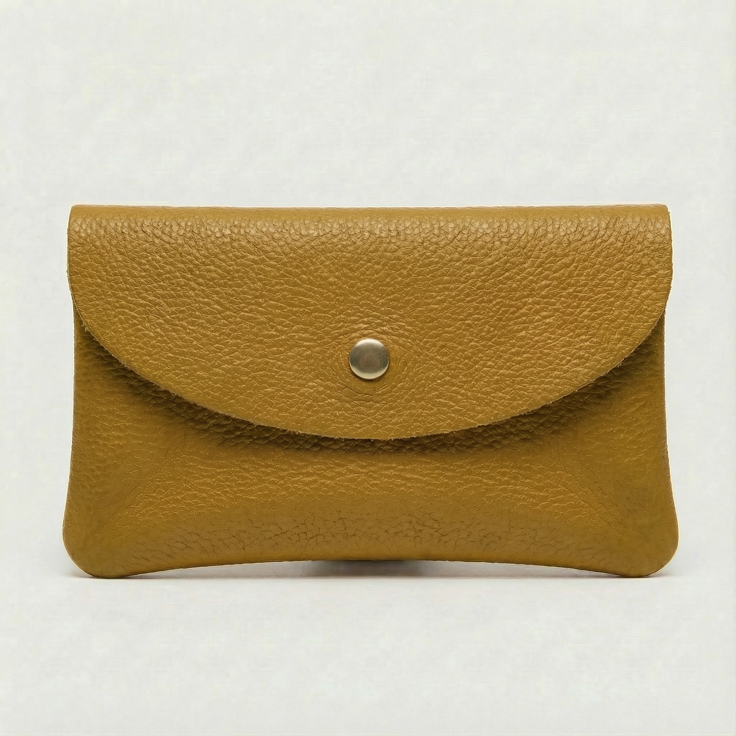 Mustard pebble leather wallet collection featuring Mini Coin Wallet, Coin Wallet, and Cellphone Wallet in genuine leather, made in Italy.