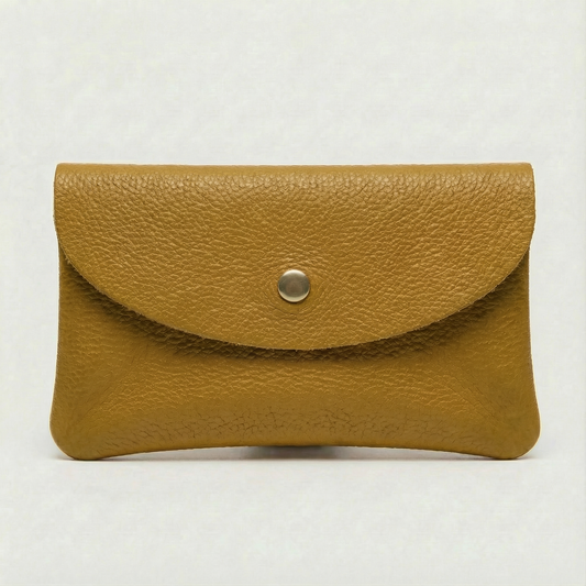 Mustard pebble leather wallet collection featuring Mini Coin Wallet, Coin Wallet, and Cellphone Wallet in genuine leather, made in Italy.