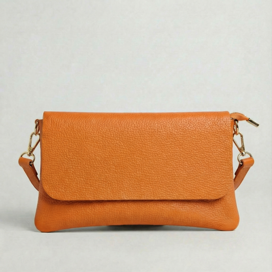 Orange pebble leather crossbody bag with a matching color adjustable strap, displayed on a light gray background.